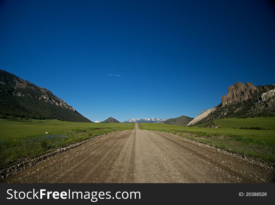 A gravel roads splits the wilderness of northern Wyoming. A gravel roads splits the wilderness of northern Wyoming.