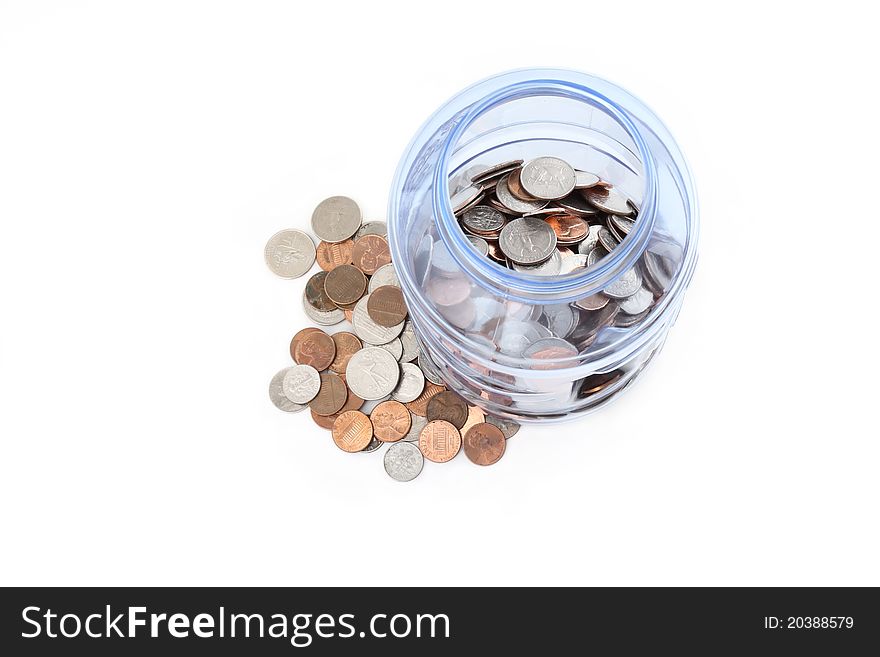 Saving money - coins in a plastic jar