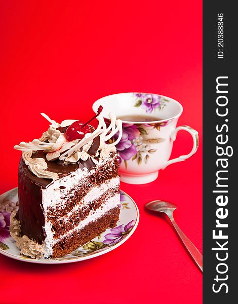 Chocolate cakes with tea on red background