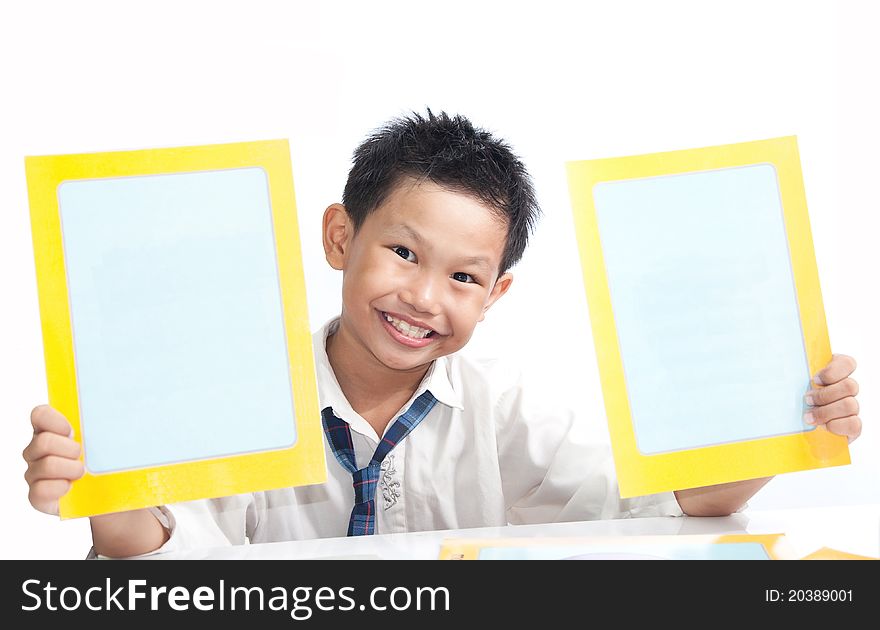 A boy holding empty frame cards on white table
