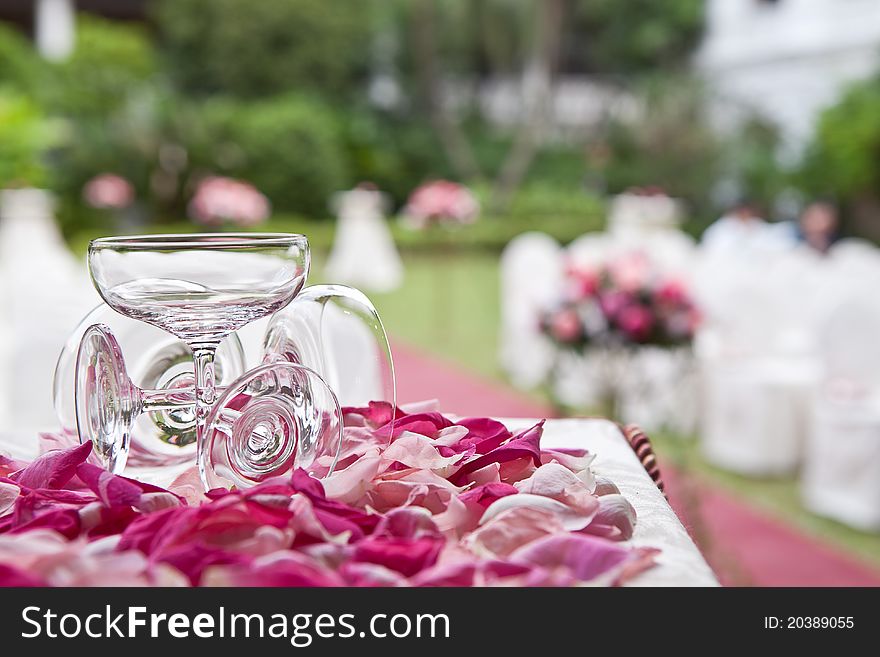 Champagne glass and rose petals at a wedding ceremony