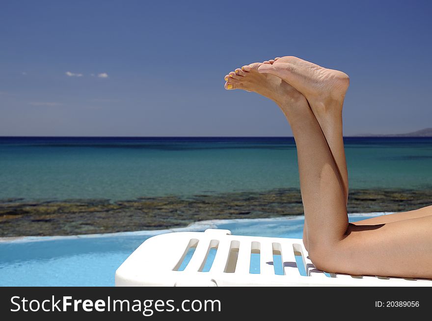 Woman over swimming pool and sea