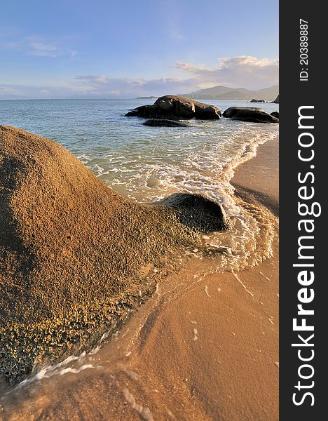 Rocky on sea beach coast under sunset warm lighting, shown as featured light, color and physiognomy. Rocky on sea beach coast under sunset warm lighting, shown as featured light, color and physiognomy.