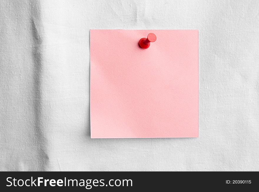 Pink note with red pin on white sheet - love message