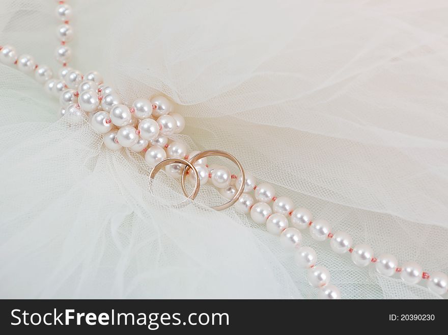 Wedding rings and a pearl necklace