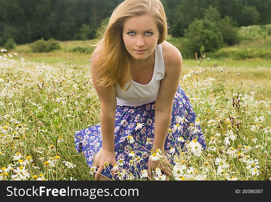 Pretty girl relaxing outdoor in grass