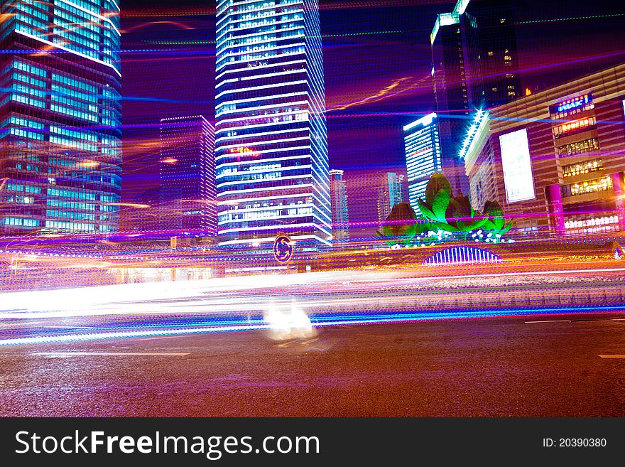 The light trails on the modern building background in shanghai china. The light trails on the modern building background in shanghai china.