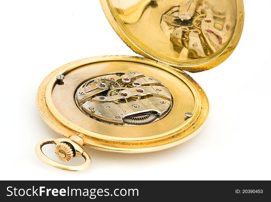 Inside of a gold pocket watch over white