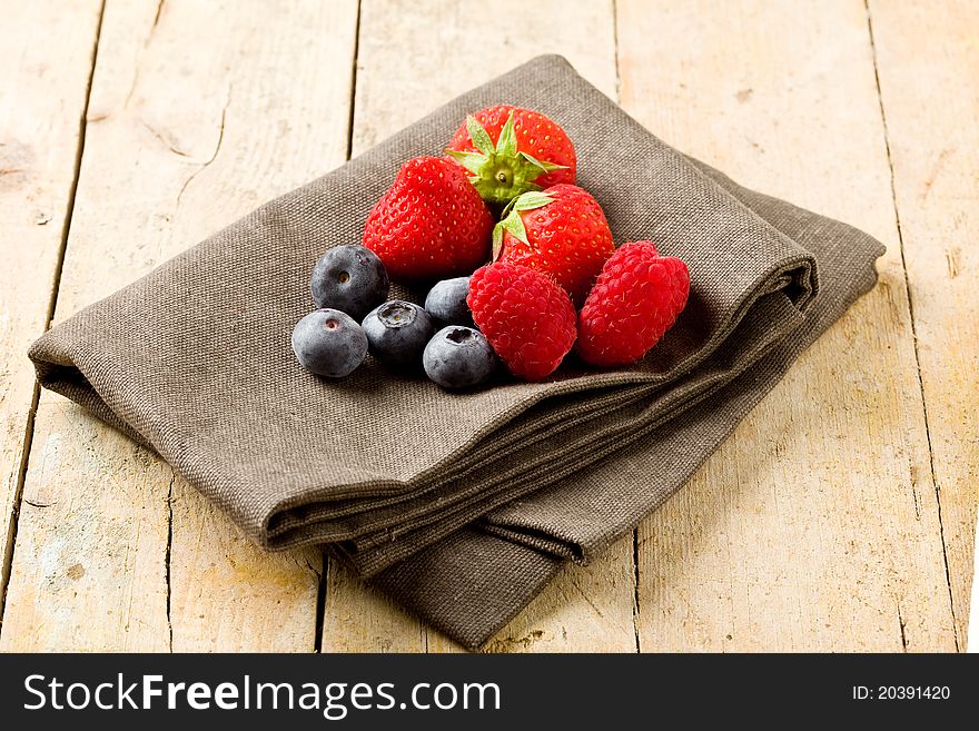 Photo of mixed fresh berries on wooden table