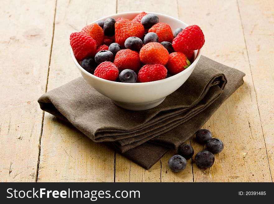 Photo of mixed fresh berries on wooden table