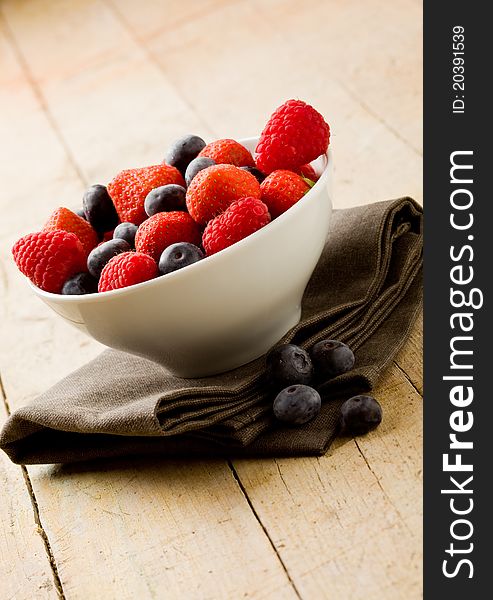 Photo of mixed fresh berries on wooden table