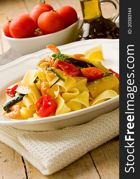 Photo of delicious italian pasta with zucchini and shrimps