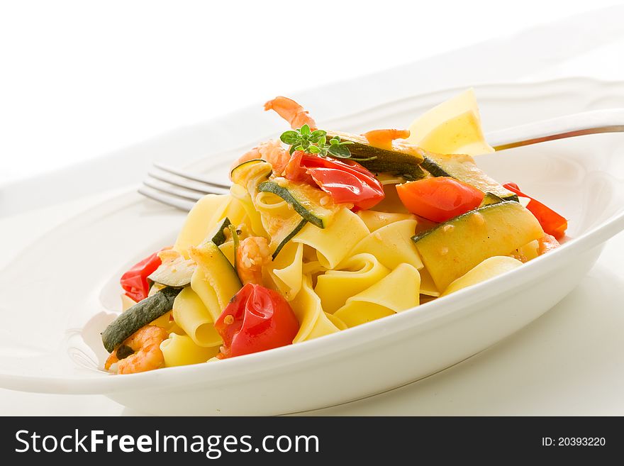 Photo of delicious pasta with zucchini and shrimps on white isolated background