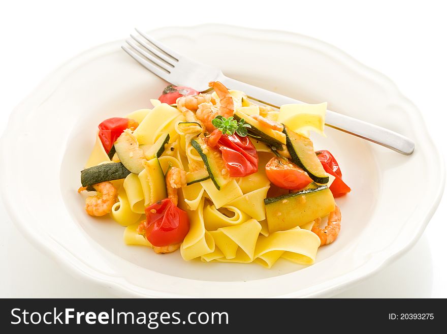 Photo of delicious pasta with zucchini and shrimps on white isolated background