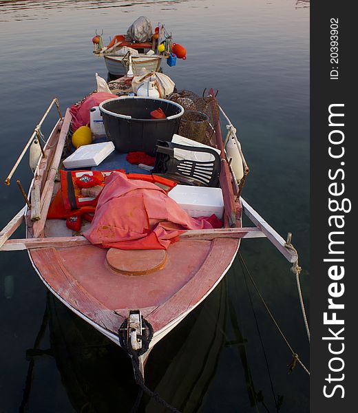 Old boat with fishing equipment on the sea. Old boat with fishing equipment on the sea