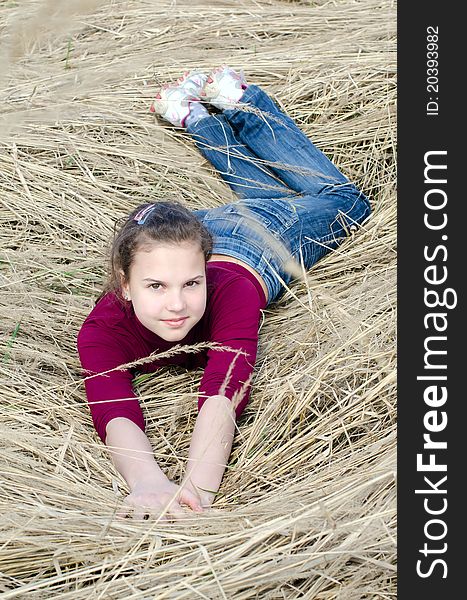 Girl Lays On A Dry Grass Outdoor