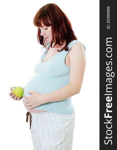 The pregnant woman with an apple on white