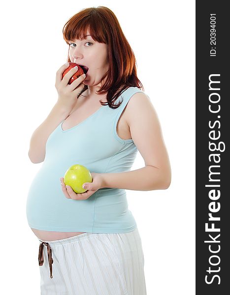 The pregnant woman with an apple isolated on white
