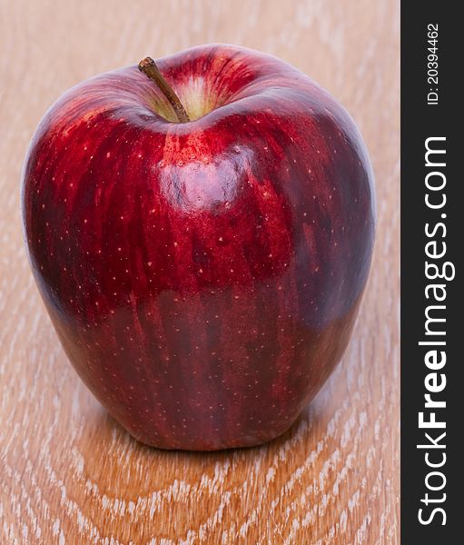 Red apple on wooden background