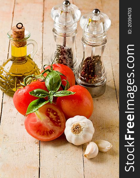 Photo of italians most used ingredients for preparing food on wooden table. Photo of italians most used ingredients for preparing food on wooden table