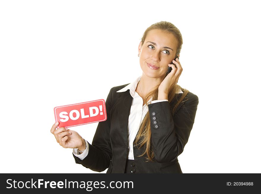 Attractive modern business woman talking on the phone and keeps the card SOLD in your other hand. isolated. Attractive modern business woman talking on the phone and keeps the card SOLD in your other hand. isolated