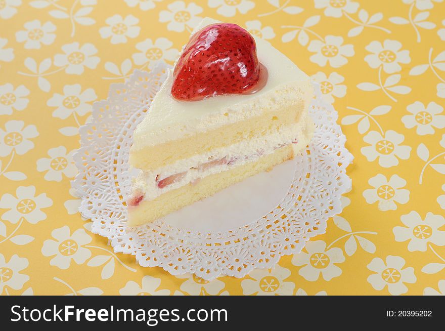 Slide of strawberry soft cake on yellow background.