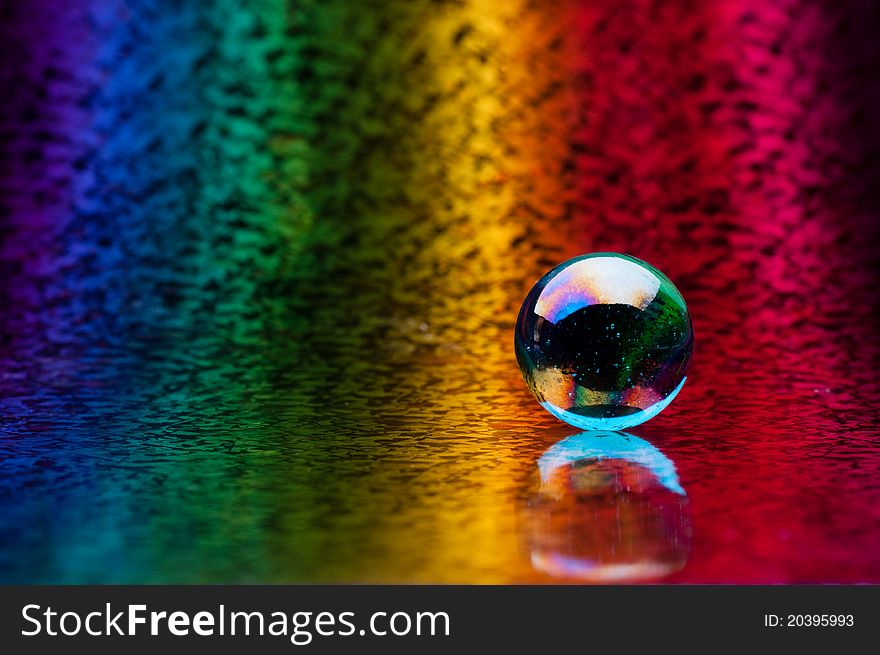 Crystal sphere on a colored background