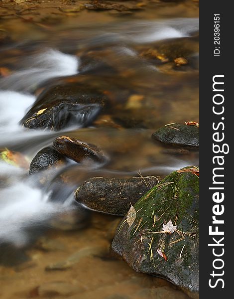 Rapids In The River In Autumn