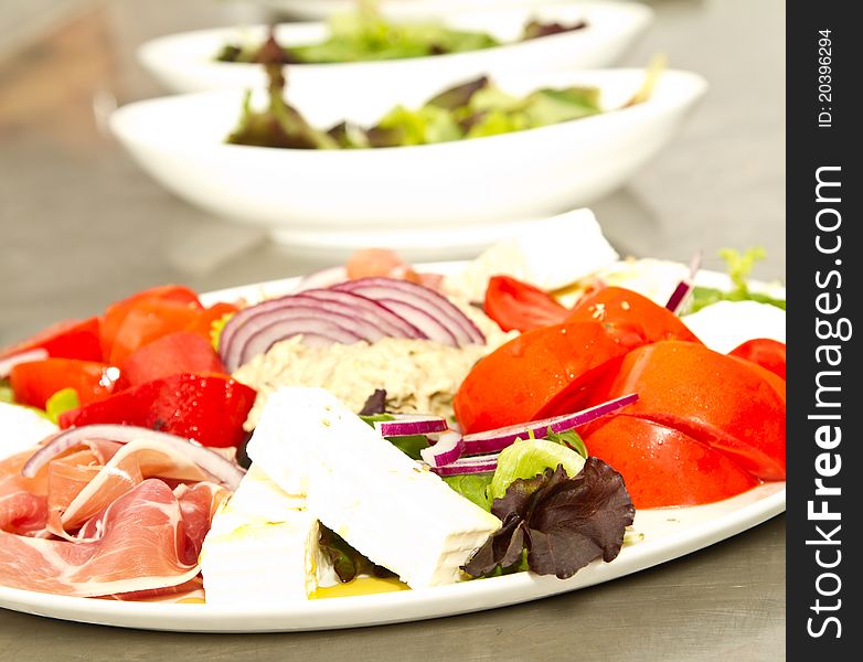 Appetizer of mixed meat, vegetables and chees (shallow DOF)