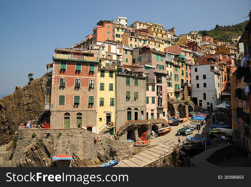 The colourful buildings around the tiny harbour of Riomaggiore, one of the stunningly beautiful Italian Cinque Terre villages and a UNESCO world heritage site. The colourful buildings around the tiny harbour of Riomaggiore, one of the stunningly beautiful Italian Cinque Terre villages and a UNESCO world heritage site.