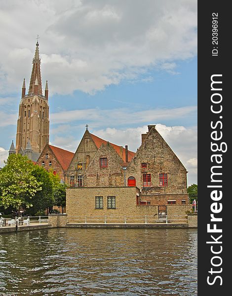 Old houses in Brugge with a bell tower in the background. Old houses in Brugge with a bell tower in the background