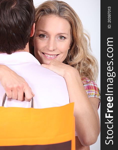 Couple hugging with a shopping bag. Couple hugging with a shopping bag