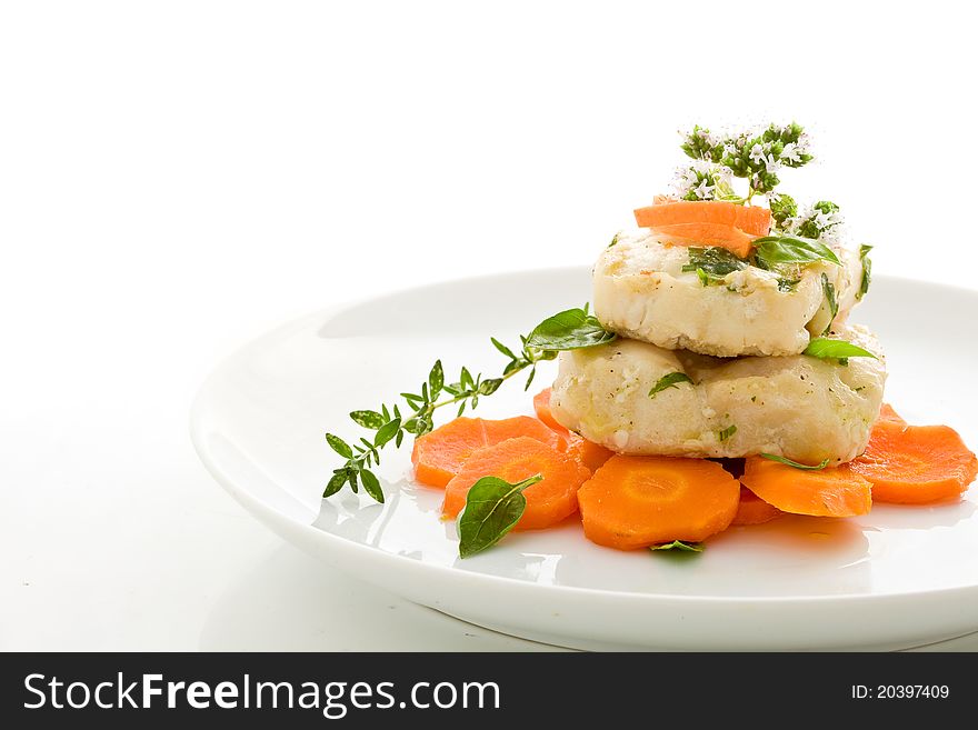 Photo of delicious cod over carrots on isolated white background. Photo of delicious cod over carrots on isolated white background