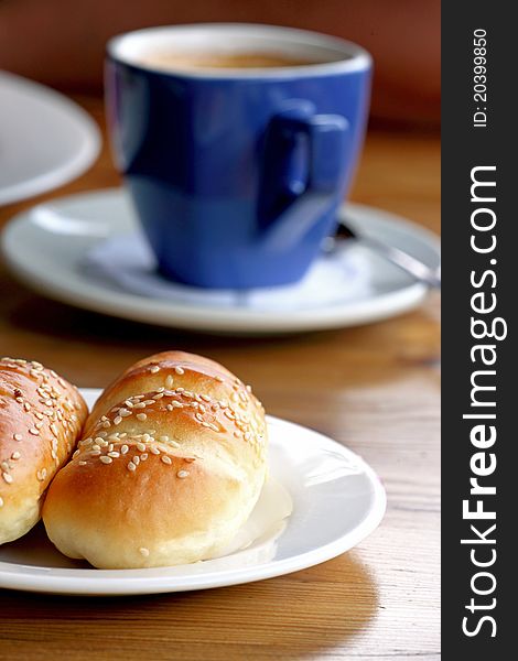 A bread and coffee on the table