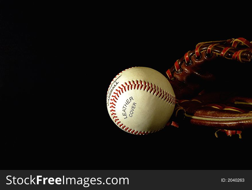 Baseball glove and ball on a black background. Baseball glove and ball on a black background