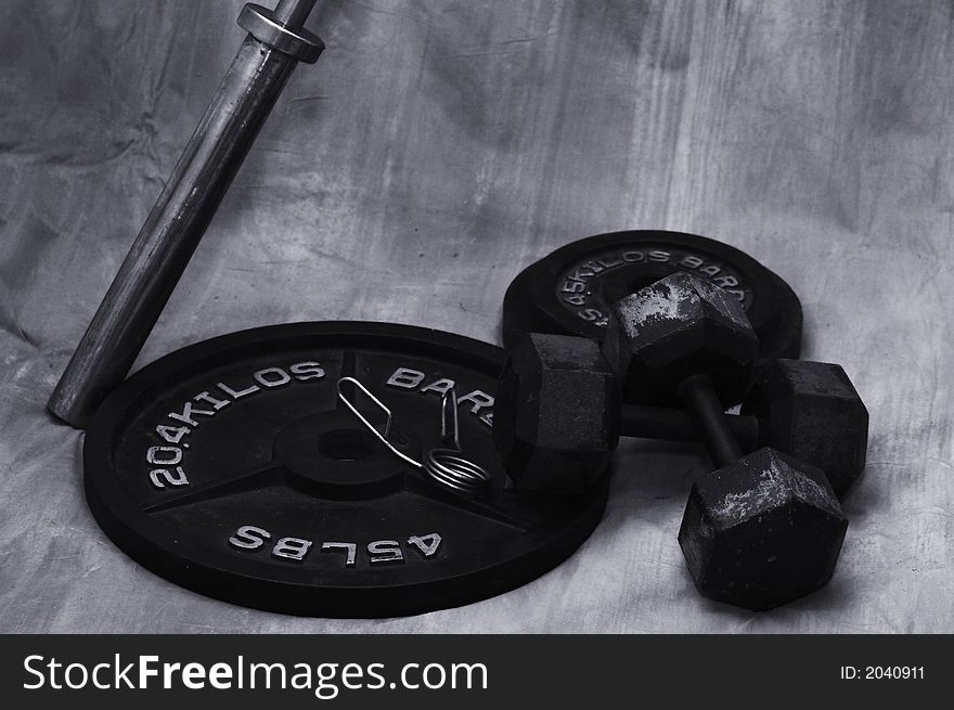 Free weights on ground with brown background. Free weights on ground with brown background
