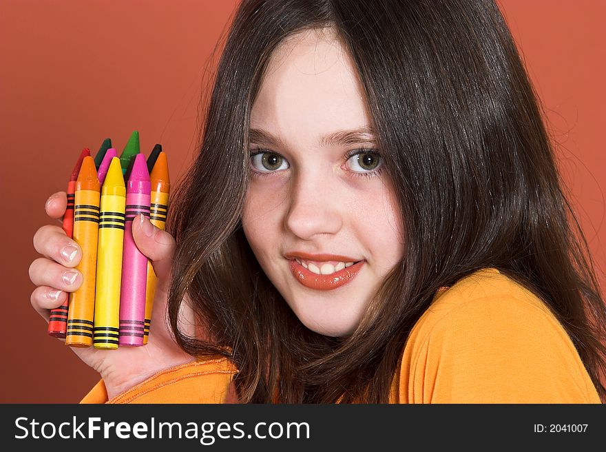 Portrait of pretty girl with colored pencils