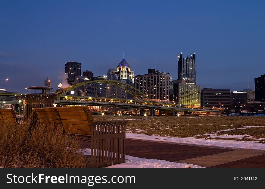 A bench with a view of downtown. A bench with a view of downtown