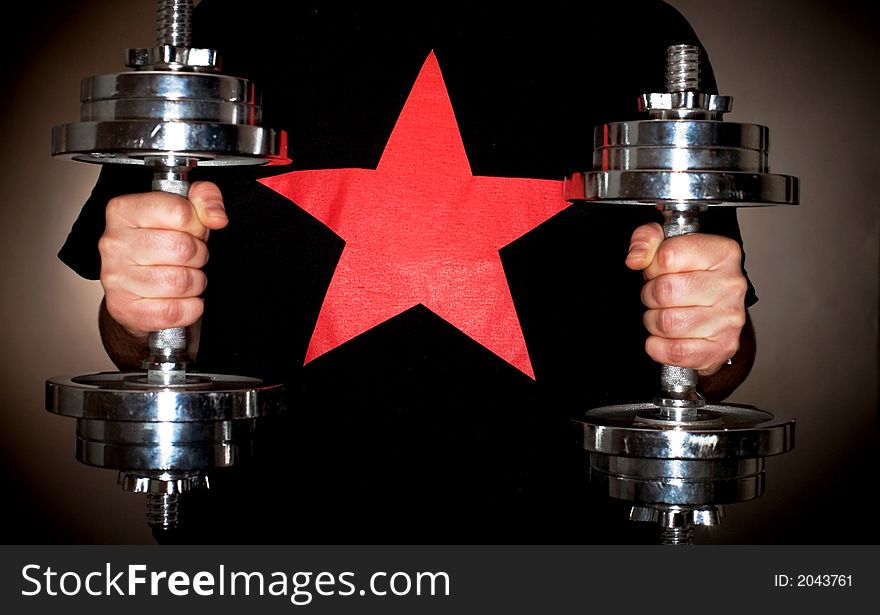 Guy with a red star T shirt holding a Weight. Guy with a red star T shirt holding a Weight