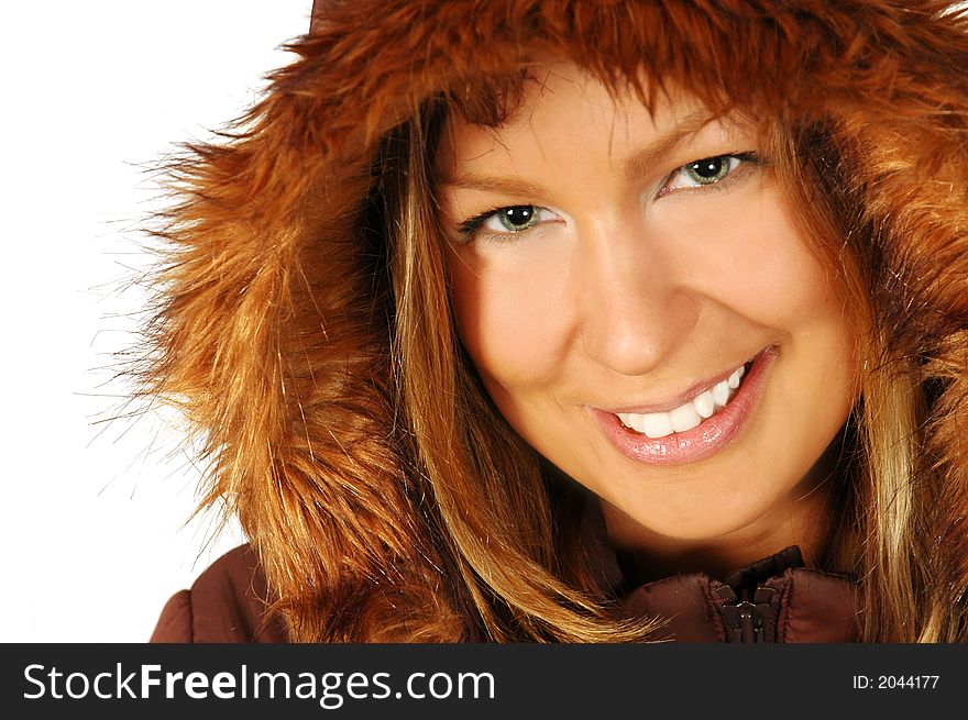 Smiling brunette wearing a winter jacket, with a fur lined hood, isolated against a white background. Smiling brunette wearing a winter jacket, with a fur lined hood, isolated against a white background.