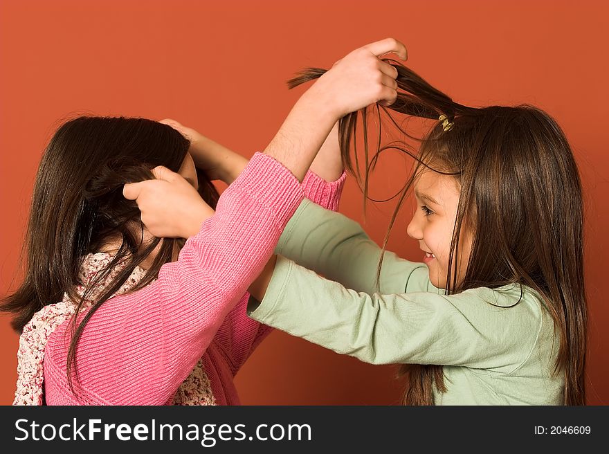 Two pretty girls touching hair