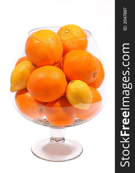 Oranges and lemons in goblet on white background