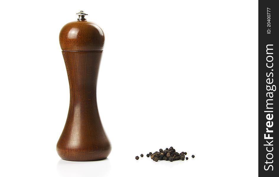 Black pepper and pepper mill on white background