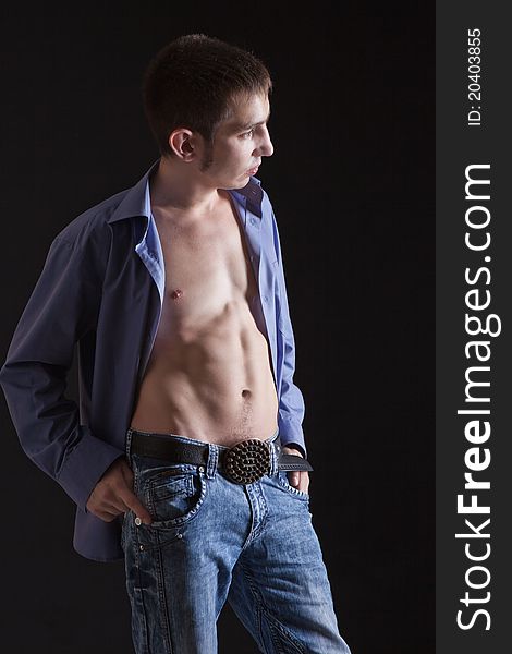 Fashion shot of a macho man. A trendy European man dressed in contemporary cloth. He is now a professional model.