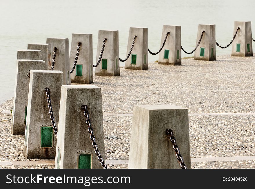 Chains and cement posts on the edge of the lake