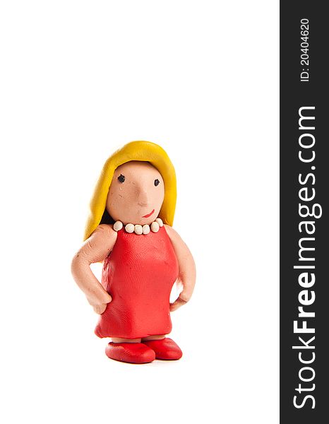 Little blond lady made of modelling clay wearing a red dress looking at the camera. Little blond lady made of modelling clay wearing a red dress looking at the camera.