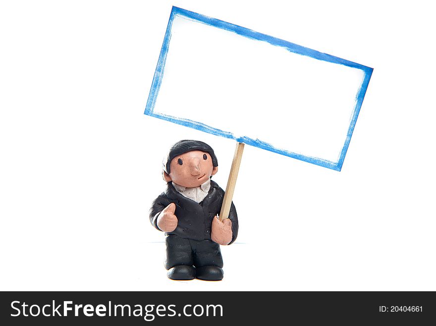 Little businessman made of modelling clay wearing a suit with thumb up holding a blank sign. Little businessman made of modelling clay wearing a suit with thumb up holding a blank sign.