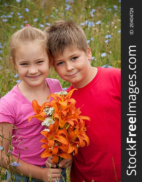 Boy and girl with a bouquet of orange lilies