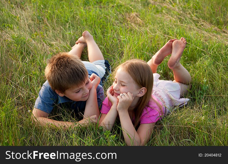 Funny Boy and girl on grass