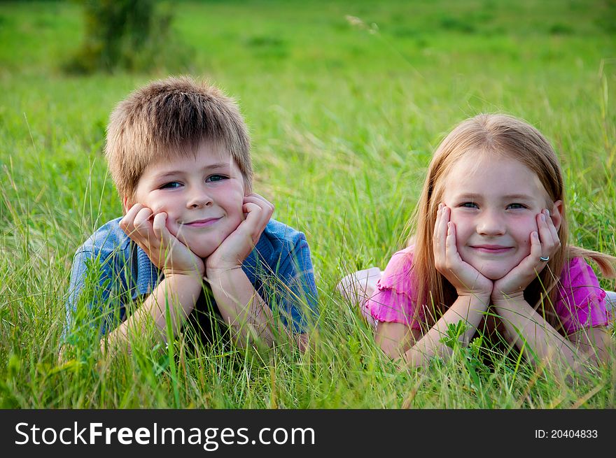 Funny Boy And Girl On Grass